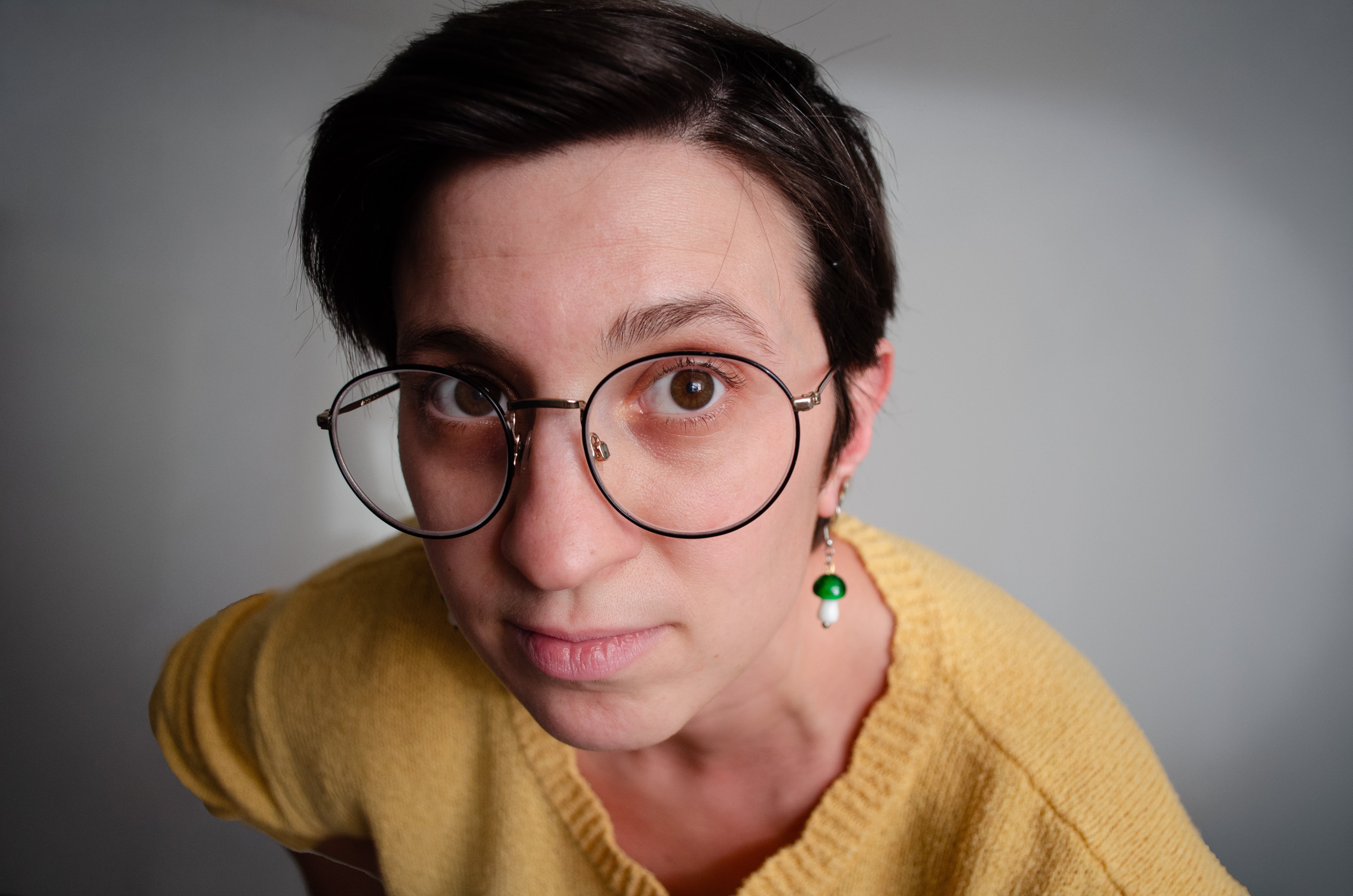 Image of Anna in a yellow shirt making a face and looking directly into the camera.